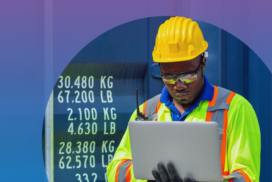 Man wearing a construction hat and working on a laptop